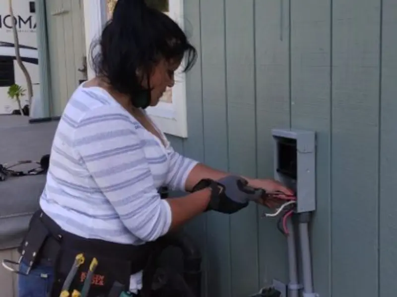 Licensed electrician wiring an exterior subpanel in Holmen